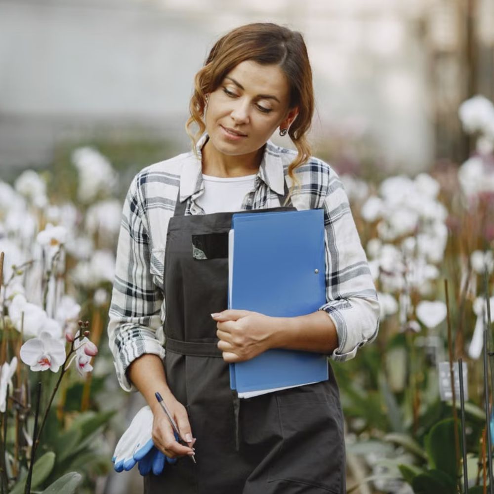 Woman enjoying time in a garden wearing outdoor clothing