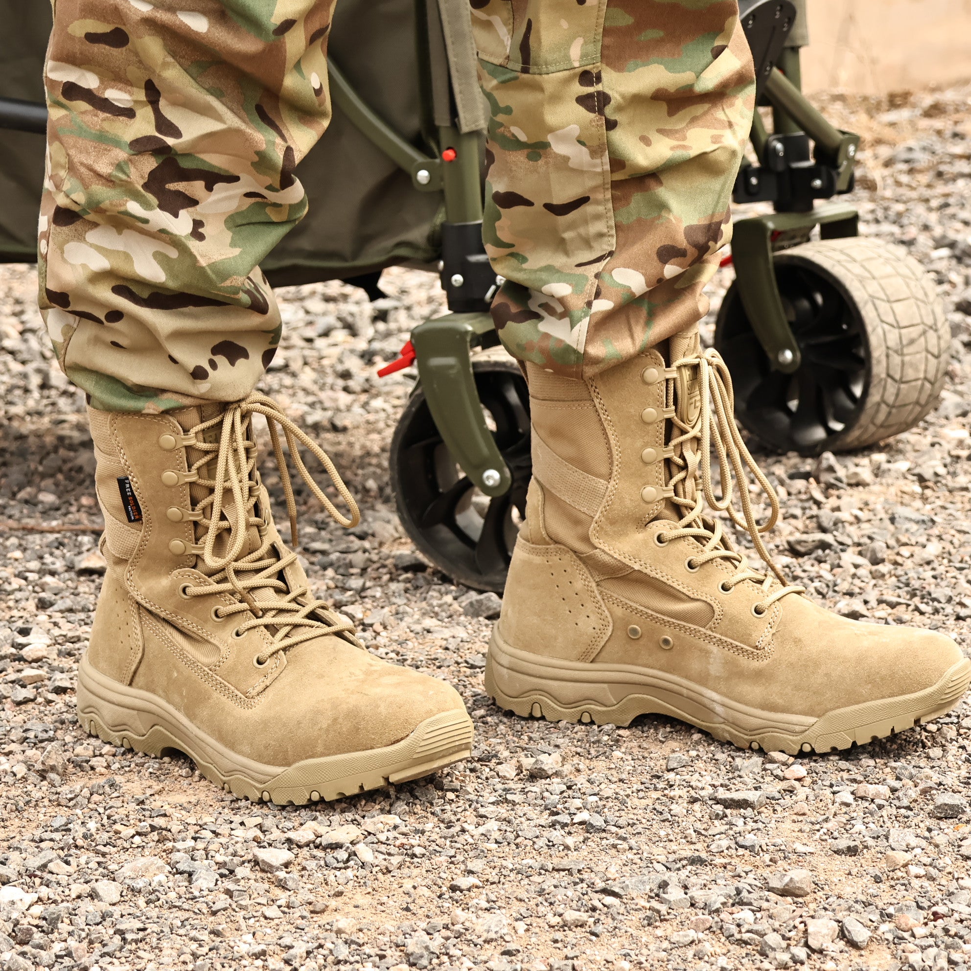 Lower body wearing camouflage pants and tan 8-inch tactical boots, highlighting the boots' tactical features