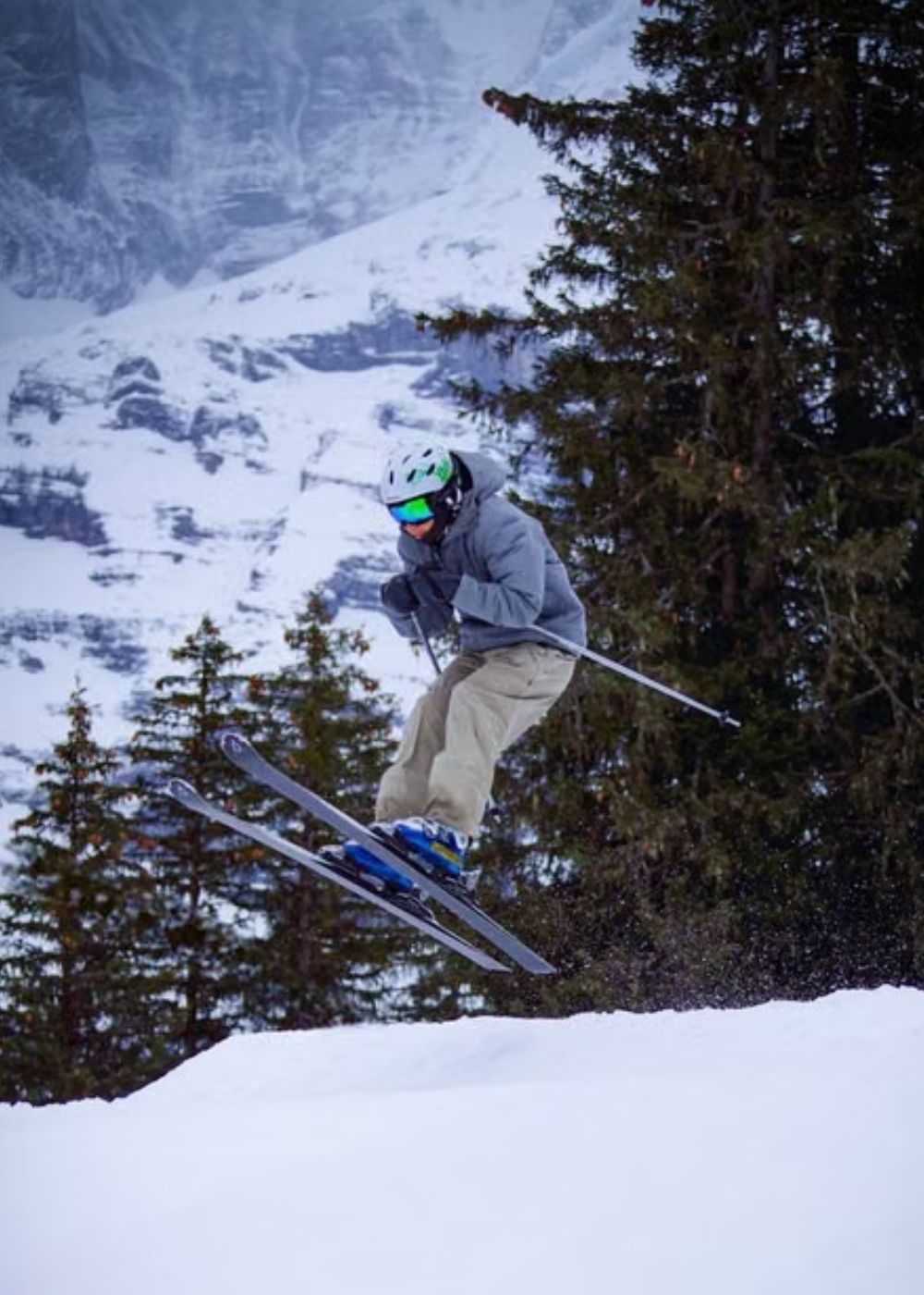 Skier wearing winter clothing while skiing on a snowy mountain